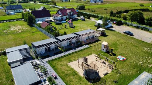 une vue aérienne d'une gare avec un train sur un champ dans l'établissement Resto domki letniskowe, à Sarbinowo