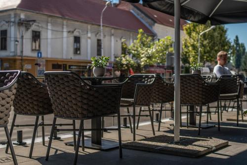 a group of chairs and an umbrella on a patio at HOTEL EUROPA in Komárno