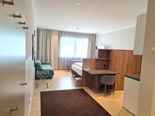 ein Schlafzimmer mit einem Bett und einem Schreibtisch in einem Zimmer in der Unterkunft TT Aparthotel Neuhofen in Neuhofen an der Krems