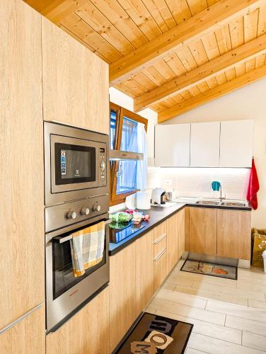 a kitchen with a stove and a microwave at Agriturismo Ardizio 43 in Pesaro