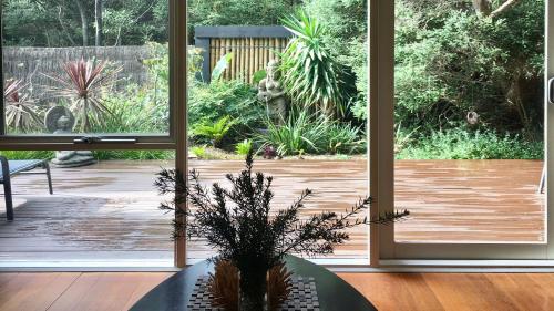 a room with a plant in a vase in front of a door at Aireys Oasis in Aireys Inlet