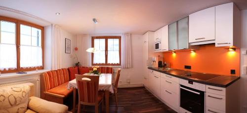 a kitchen with a table and a dining room at Ferienwohnung Erhard in Silbertal