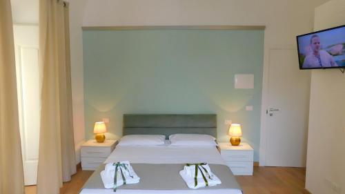 Ένα ή περισσότερα κρεβάτια σε δωμάτιο στο B&B La Maison del Borgo