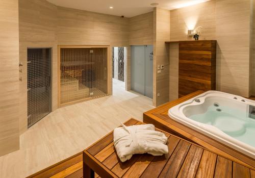 a bathroom with a jacuzzi tub in a room at Admiral Hotel in Zagreb