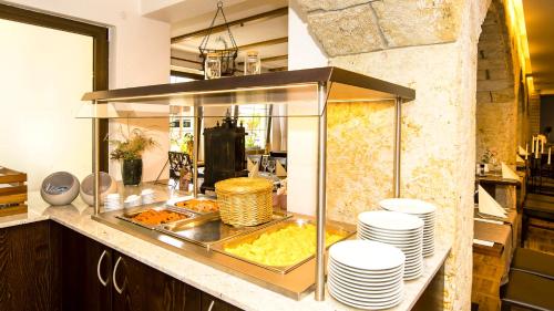a kitchen with a buffet with plates and food at Hotel Zur Post in Pirna