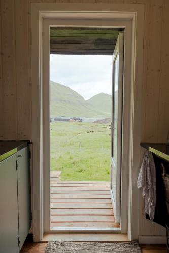 an open door with a view of a field at Authentic Cabin - Unique location - In nature - 2BR in Hellur