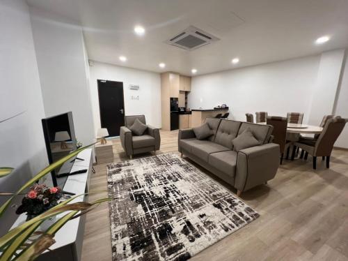 a living room with a couch and chairs and a table at Ramada by Wyndham Langkawi Marina in Kuah