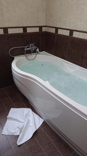 a bath tub filled with blue water in a bathroom at Apartamento Ginette SunBeach in Salou