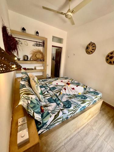 a bedroom with a bed and a table at Gadea Boutique Hotel& Gadea Garden Italian Restaurant in Jambiani