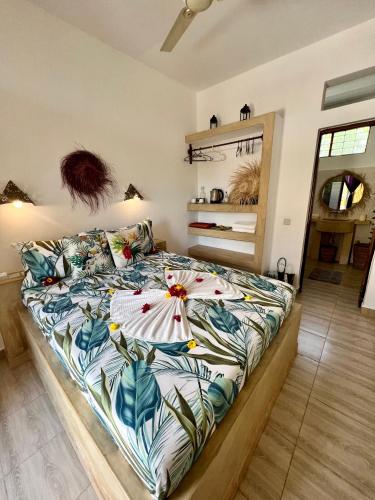 a bedroom with a bed with a colorful comforter at Gadea Boutique Hotel& Gadea Garden Italian Restaurant in Jambiani
