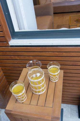 four glasses of lemonade on a wooden table at kadarim Boutique Suites-beachfront Zimmer in Haifa