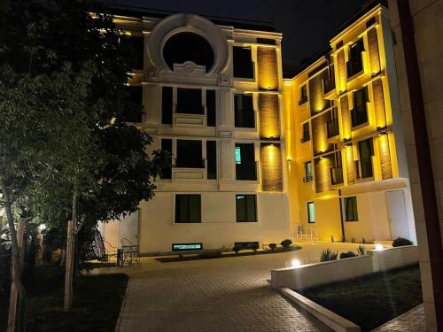 a large building at night with its lights on at Orden Hotel in Tbilisi City