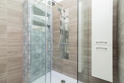 a shower with a glass door in a bathroom at Perła Starego Miasta Kamienica Czapskich by Renters in Krakow