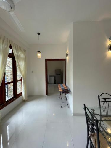 a living room with a table and chairs in it at Welaratne Apartment in Nugegoda