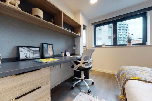 a bedroom with a desk with a chair and a bed at Canvas Wembley in London in London
