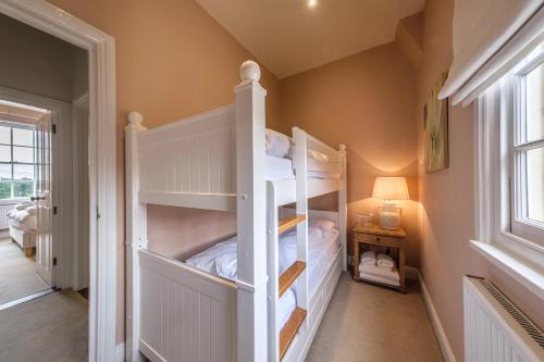 a bedroom with two bunk beds in a room at The Black Lion, Long Melford in Long Melford