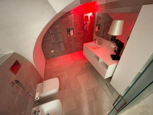 a bathroom with a toilet and a sink and a mirror at Loft “Cinema Galleria” in Bari