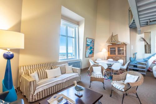 un salon avec un canapé, des chaises et une table dans l'établissement SUN KEYWEEK Duplex Breathtaking view of the Ocean and Palace Gardens, à Biarritz