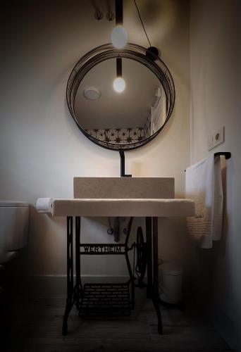 a bathroom with a sink and a mirror at Casa de las Lías in Chinchón