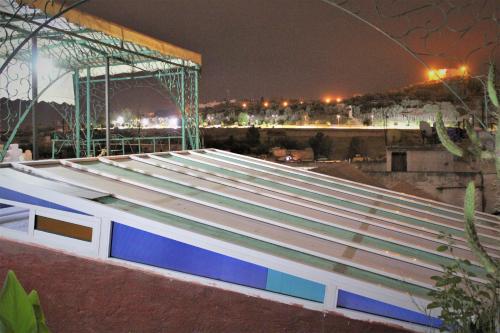 a view of the roof of a building at night at Maison Adam in Fès