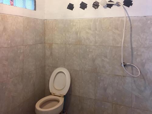 a bathroom with a toilet and a shower at Olala Bungalows And Restaurant Mitra RedDoorz in Banda Aceh