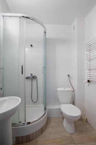 a bathroom with a shower and a toilet and a sink at Mixbud in Biała Podlaska