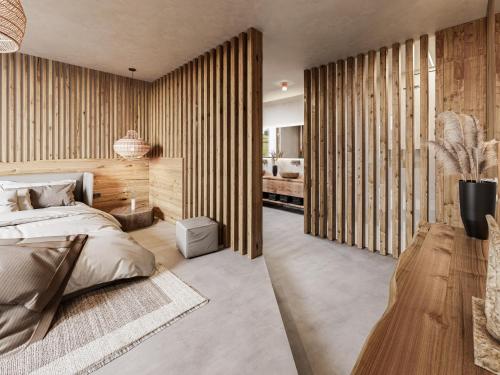 a bedroom with a bed and a wooden wall at 4Monkeys Apartments in Balderschwang