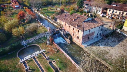 an aerial view of an old building with a train yard at Cascina Mora Bassa in Vigevano