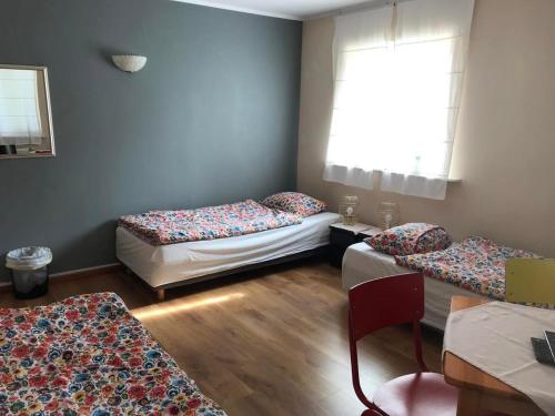 a room with two beds and a window at Agroturystyka Mętno 18 in Mętno