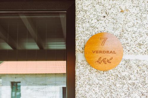a wooden sign on the side of a building at Oliveiras Village — Agroturismo in Amarante