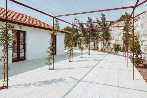 an empty courtyard with trees in a building at Oliveiras Village — Agroturismo in Amarante