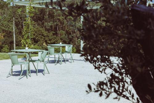 a group of tables and chairs in a patio at Oliveiras Village — Agroturismo in Amarante