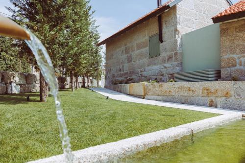 a water fountain in front of a building at Oliveiras Village — Agroturismo in Amarante