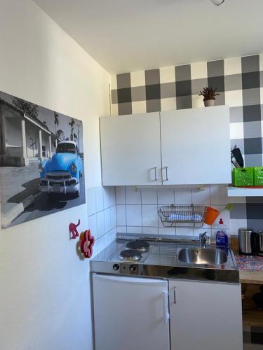 a kitchen with a sink and a car on the wall at Mini-Ferien-Suite Hildesheim in Hildesheim