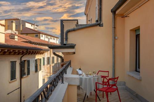 a balcony with a table and chairs on a building at Hotel Colomba d'Oro in Verona