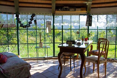 a bedroom with a table and chairs in front of a window at Limosa Country House in Spigno Saturnia