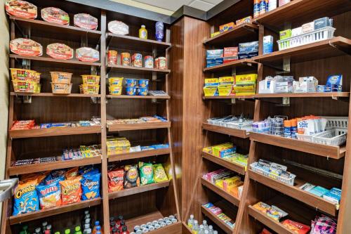 a grocery store aisle with many shelves of food at Hawthorn Suites by Wyndham Williston in Williston
