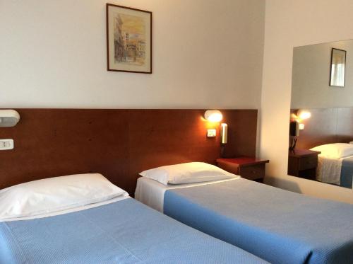 A bed or beds in a room at Hotel San Marco