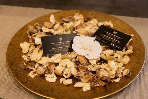 a plate of mushrooms on a table with two signs at Jadore Monic in Rome