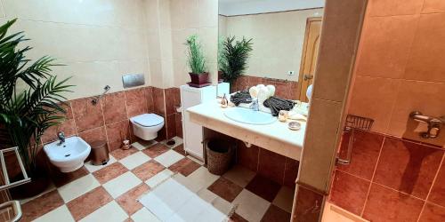 a bathroom with a sink and a toilet at Best4U Nautico in San Miguel de Abona