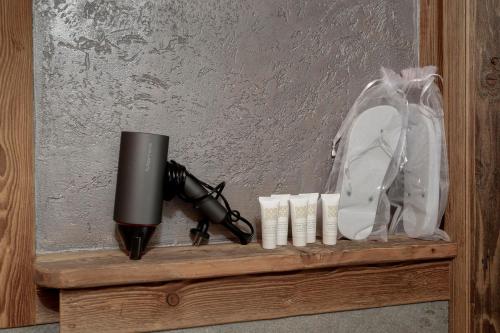 a shelf with a camera and a bag and a gun at Ski Apartment Francois Hot Tub & Central Location with hotel services in Breuil-Cervinia