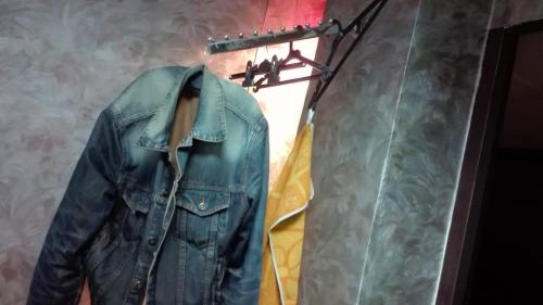 a denim jacket is hanging on a rack at Стаи на пъпа на Варна, входа на Морската градина in Varna City