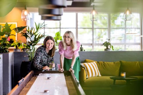 two women sitting at a table in a room at Pier 5 Hotel in Aalborg
