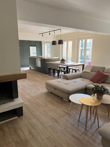 a living room with a couch and a table at Appart'Alencon in Alençon