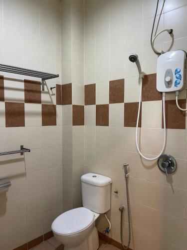 a bathroom with a toilet and a shower at Fresh Hotel Falim in Ipoh