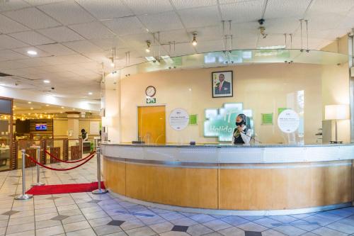 a person taking a picture of a counter in a store at Holiday Inn - Bulawayo by IHG in Bulawayo