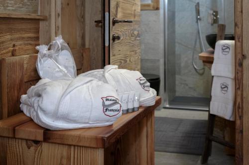 a pile of towels sitting on a counter in a bathroom at Ski Apartment Francois Hot Tub & Central Location with hotel services in Breuil-Cervinia