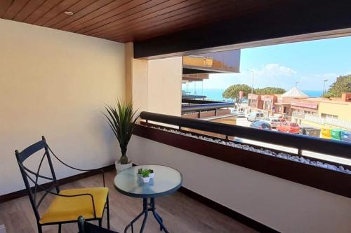 a table and two chairs in a room with a window at Health Village Apartments in Cascais