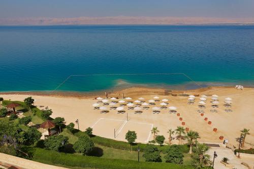 an aerial view of a beach with umbrellas at Crowne Plaza Jordan Dead Sea Resort & Spa, an IHG Hotel in Sowayma