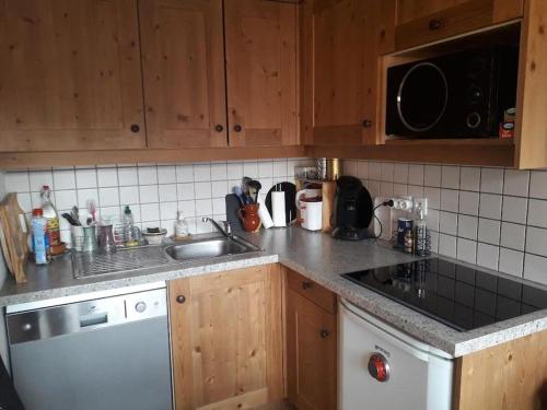a kitchen with a sink and a counter top at T3 puy st Vincent 1800 in Puy-Saint-Vincent
